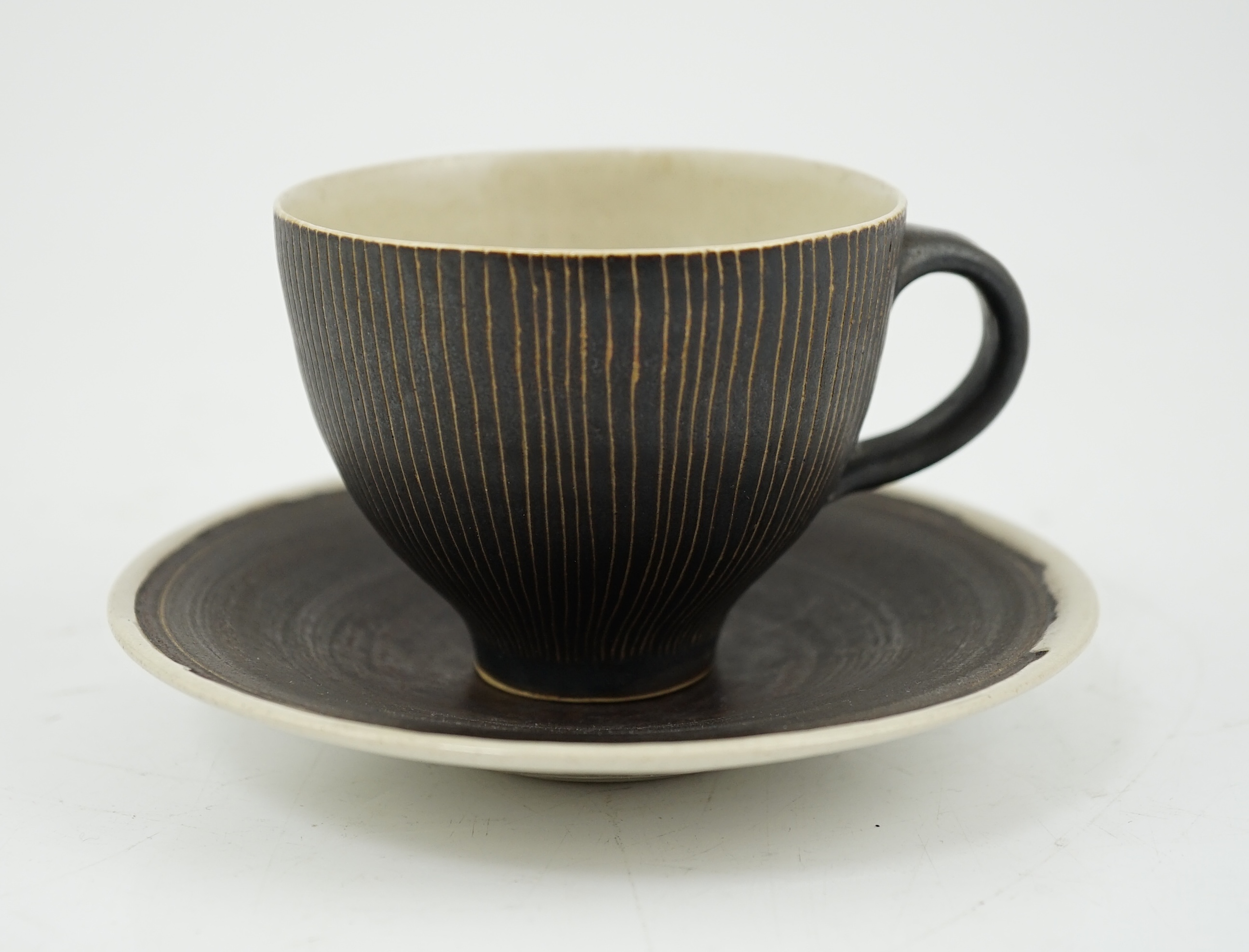 Dame Lucie Rie D.B.E. (1902-1995), a manganese glazed coffee cup and saucer